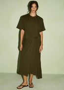 Woman modelling a olive dress on light green background