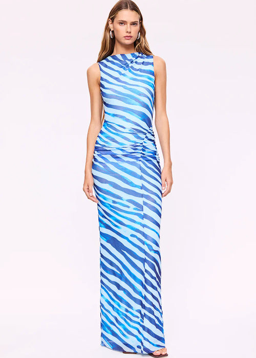 Woman wearing a blue and white patterned dress on a white background