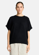 Woman wearing a black sweater  on a white background