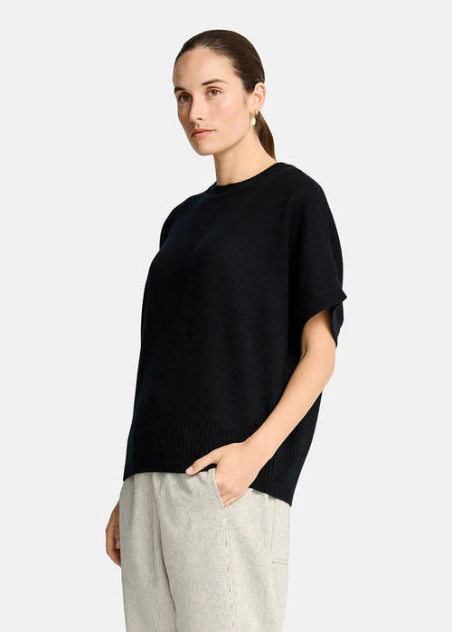 Woman wearing a black sweater  on a white background