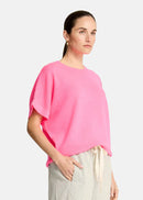 Woman wearing a pink top on a white background