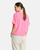 Woman wearing a pink top on a white background