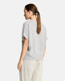 Woman wearing a grey sweater  on a white background