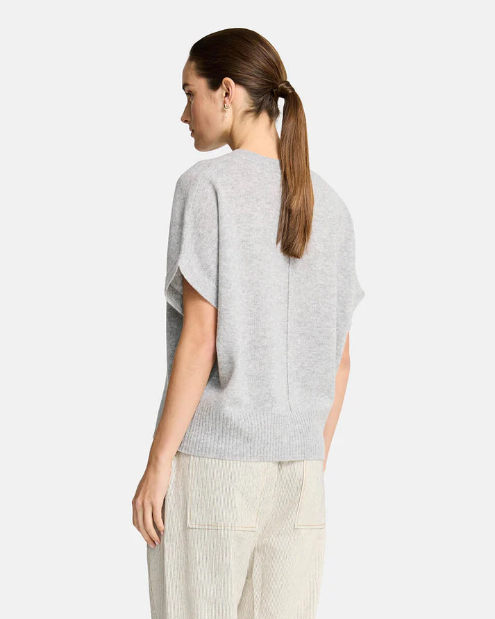 Woman wearing a grey sweater  on a white background