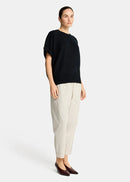 Woman wearing a black sweater  on a white background