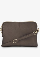 A dark brown pebbled leather crossbody bag with gold-tone hardware and a matching leather strap, shown against a plain white background.