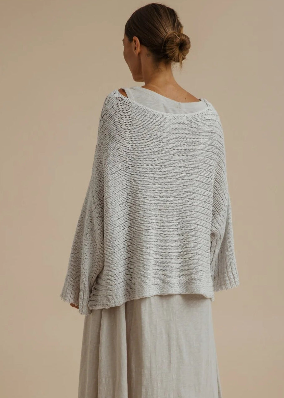Woman weary silver knitted top on beige background