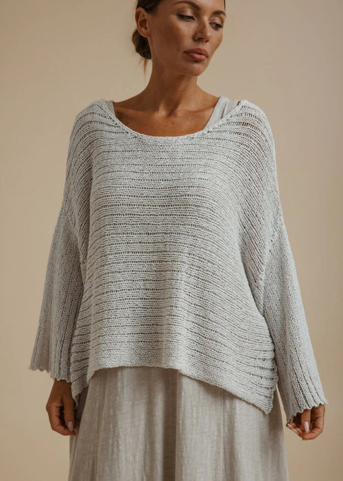 Woman weary silver knitted top on beige background