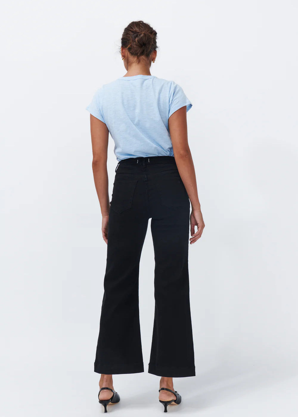 Woman wearing black jeans on white background