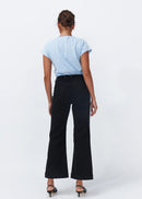 Woman wearing black jeans on white background
