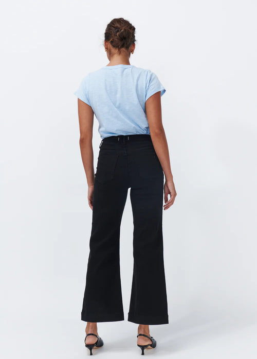 Woman wearing black jeans on white background