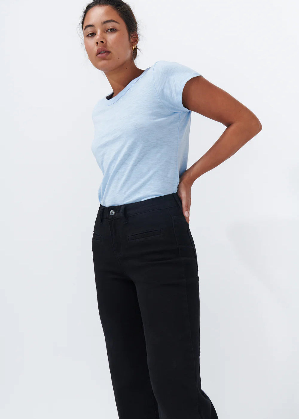 Woman wearing black jeans on white background