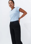 Woman wearing black jeans on white background