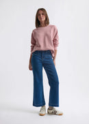 Woman wearing blue jeans on a white background