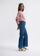 Woman wearing blue jeans on a white background