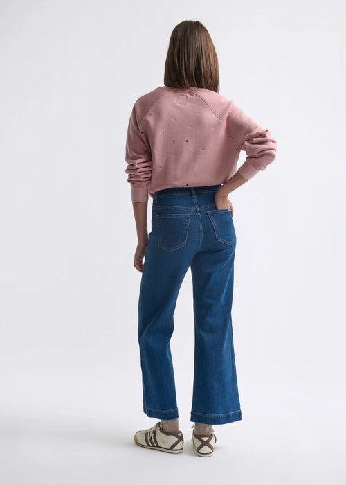 Woman wearing blue jeans on a white background