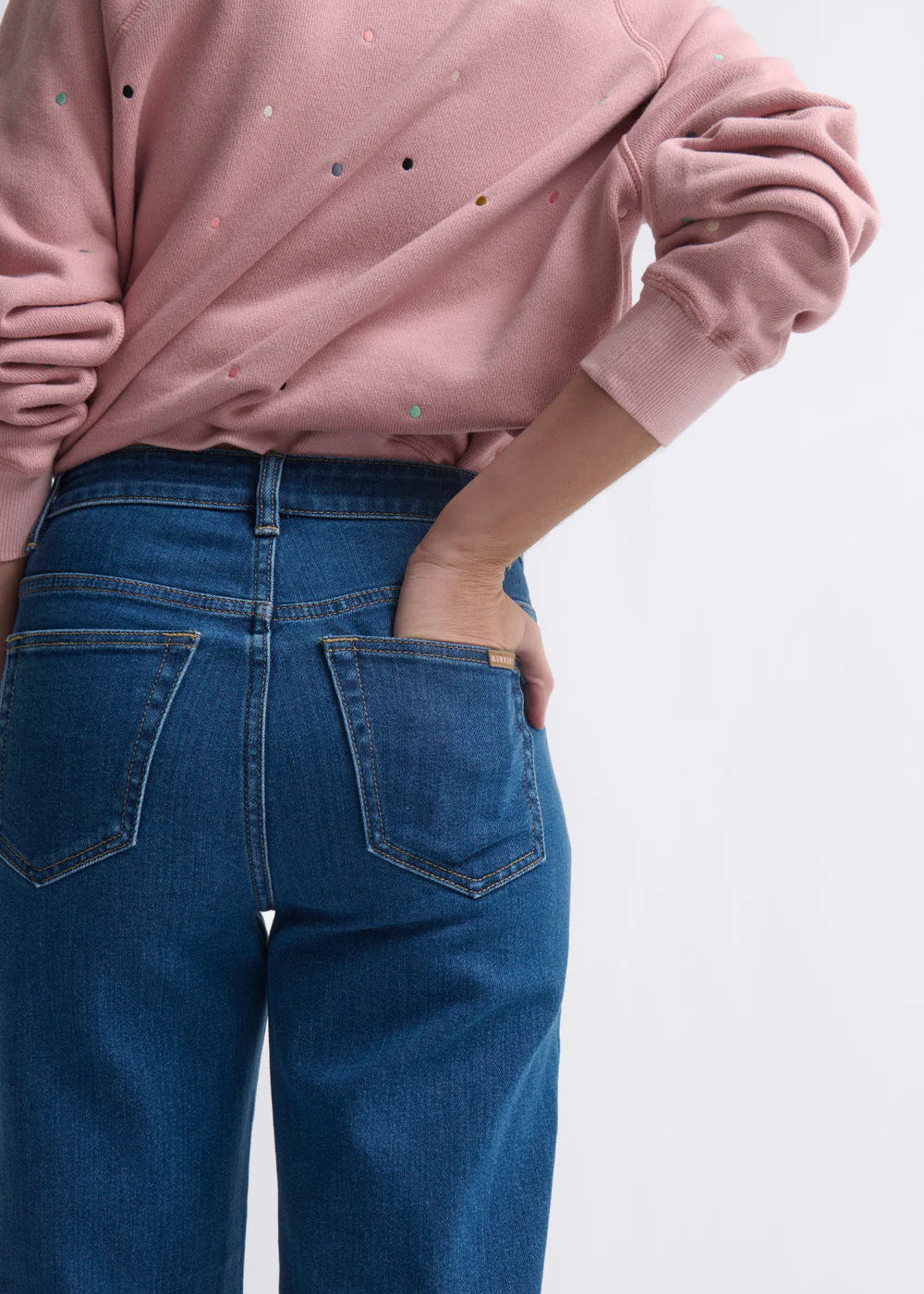 Woman wearing blue jeans on a white background