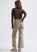Woman wearing beige jeans on white background