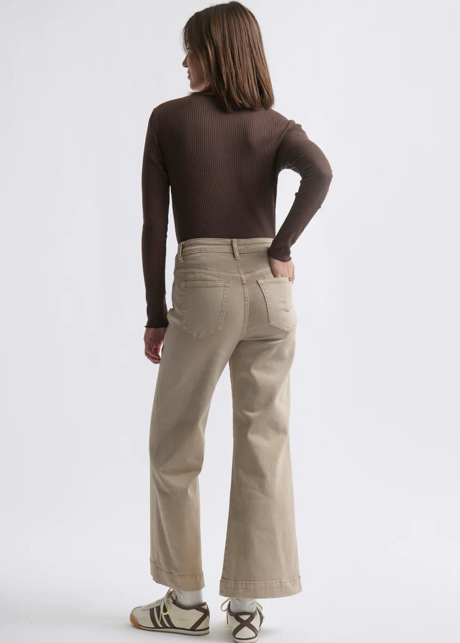 Woman wearing beige jeans on white background