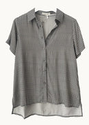 A short-sleeve button-up shirt with a black and white gingham check pattern, displayed on a hanger against a plain off-white background.