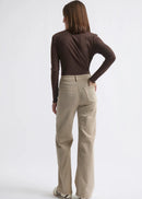 Woman wearing beige jeans on white background