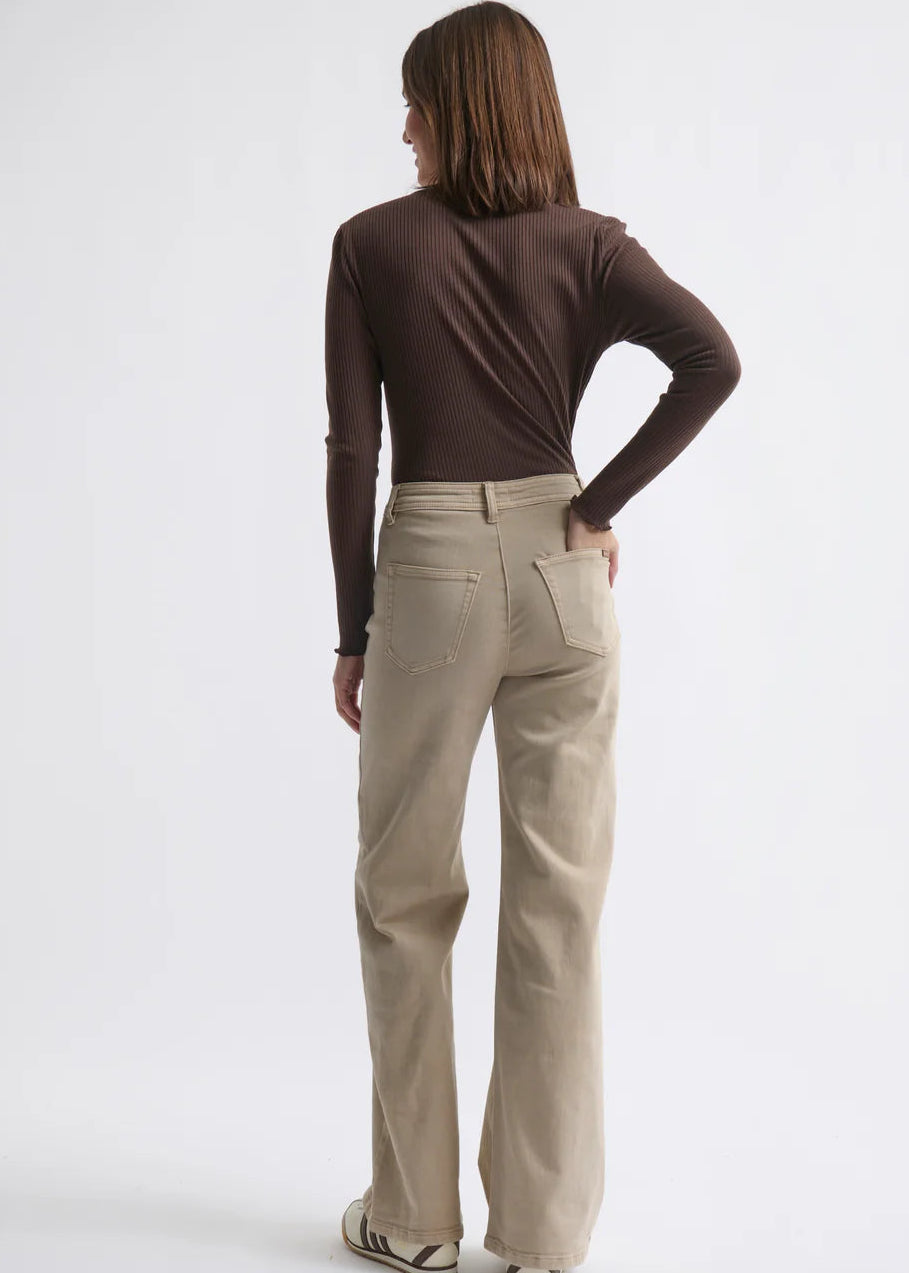 Woman wearing beige jeans on white background