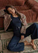 Woman wearing jeans sitting on the floor