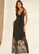 Woman wearing a black slip dress with lace details on a neutral background