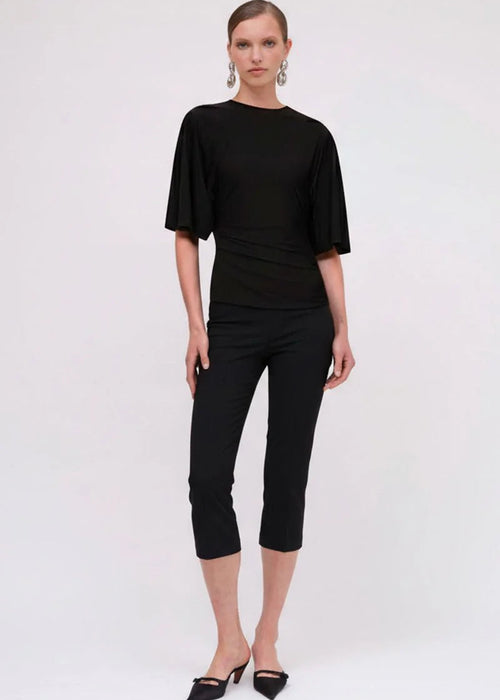 Woman wearing a black top on a white background