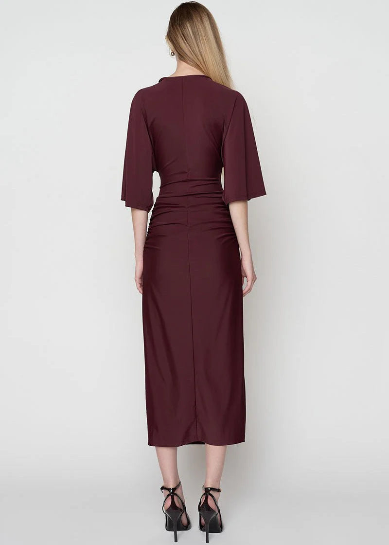 Woman wearing a burgundy dress on a white background