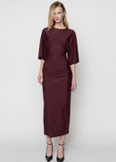 Woman wearing a burgundy dress on a white background