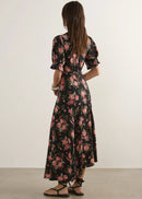 Woman wearing  floral dress on a wite background