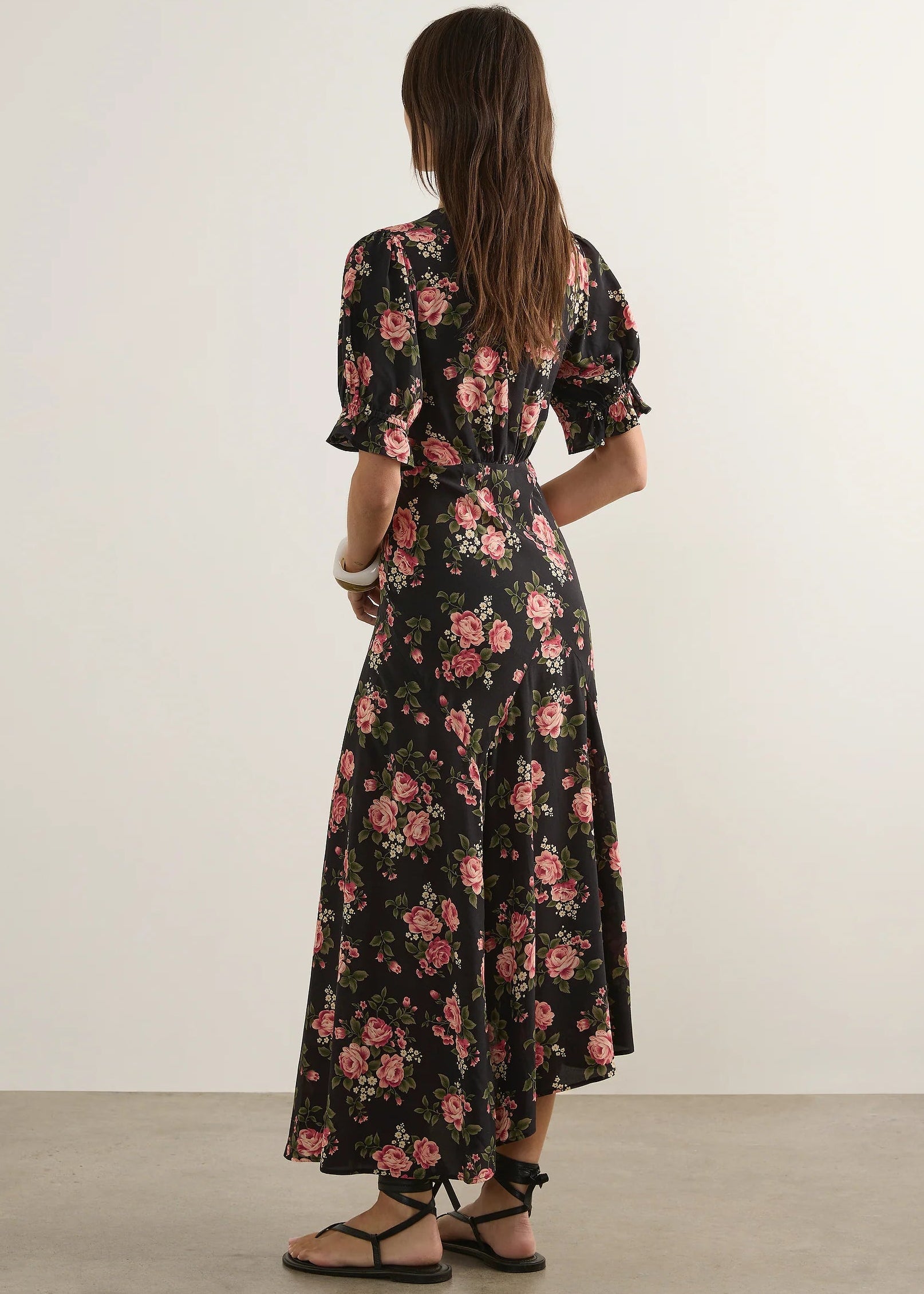 Woman wearing  floral dress on a wite background