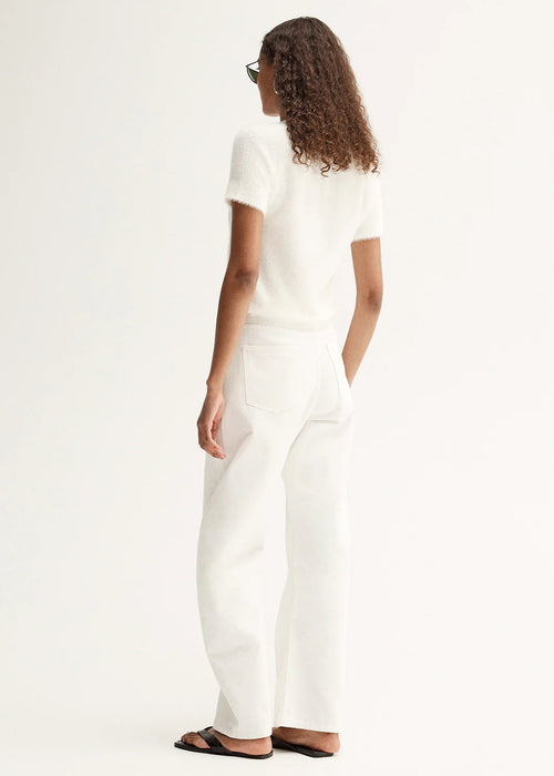 Person wearing a white outfit on a plain background