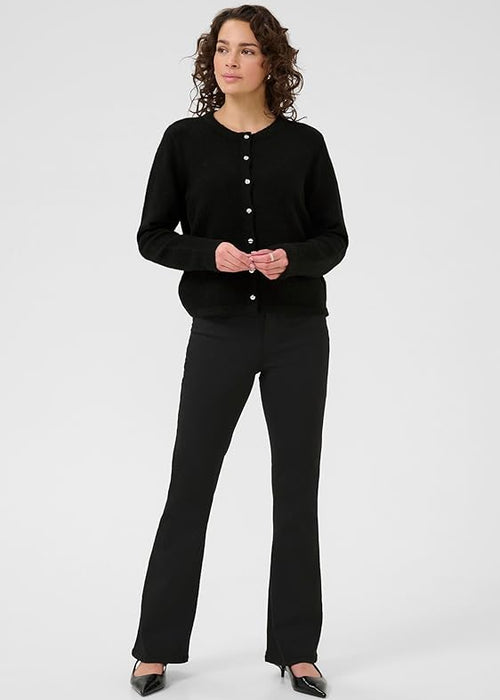Woman wearing black cardigan on a white background