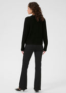 Woman wearing black cardigan on a white background