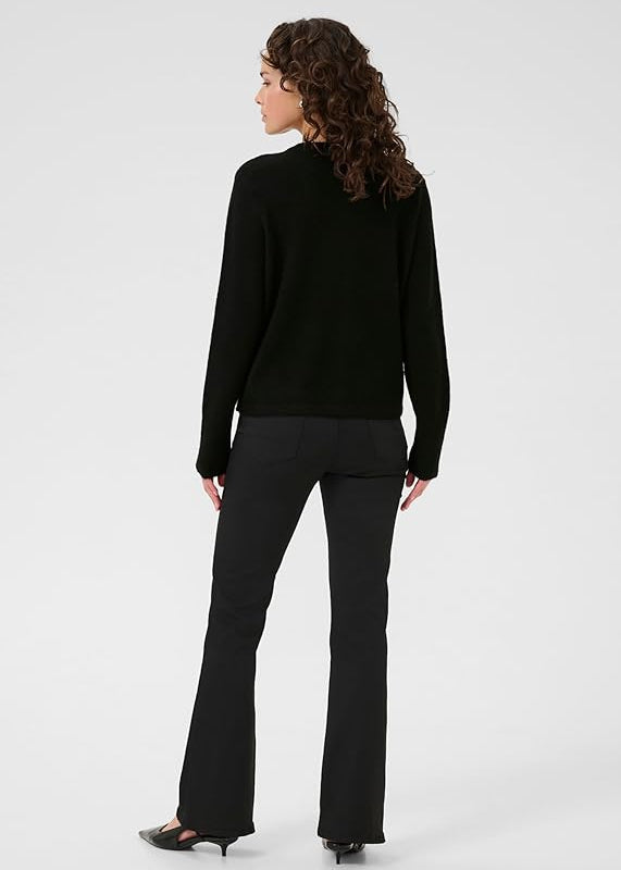 Woman wearing black cardigan on a white background