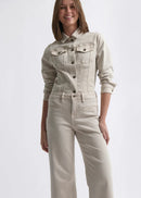 Woman wearing a beige denim jacket and pants on a white background