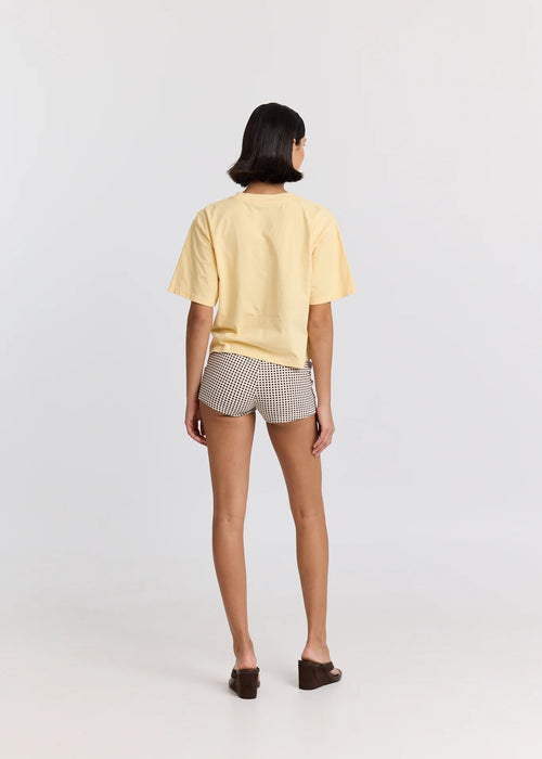 Person wearing a yellow t-shirt and checkered shorts on a white background

Details