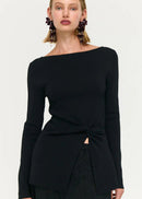Woman wearing black top and skirt on white background