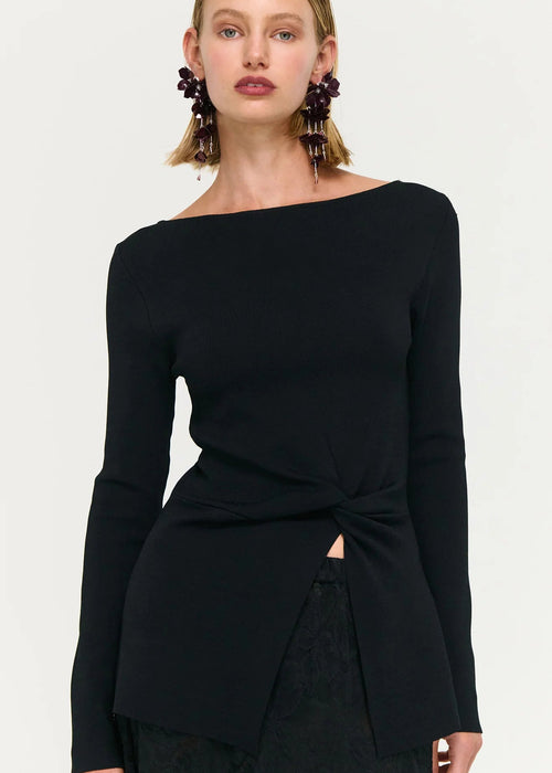 Woman wearing black top and skirt on white background