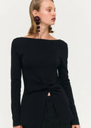 Woman wearing black top and skirt on white background