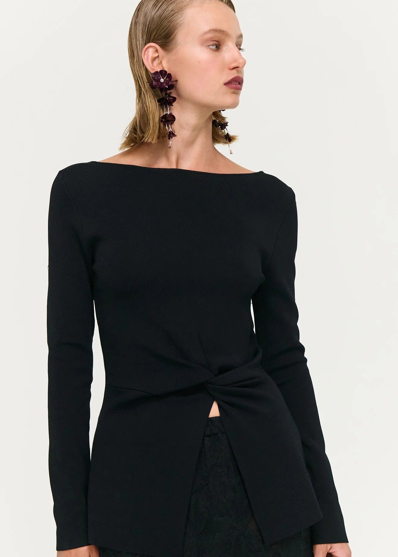 Woman wearing black top and skirt on white background