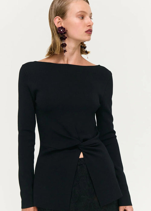 Woman wearing black top and skirt on white background