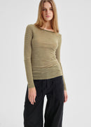 Woman wearing a striped long-sleeve top and black pants on a light gray background