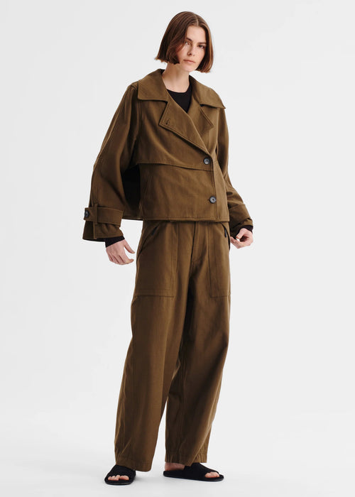 Woman wearing a brown pant on a white background