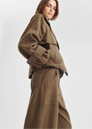 Woman wearing a brown pant on a white background