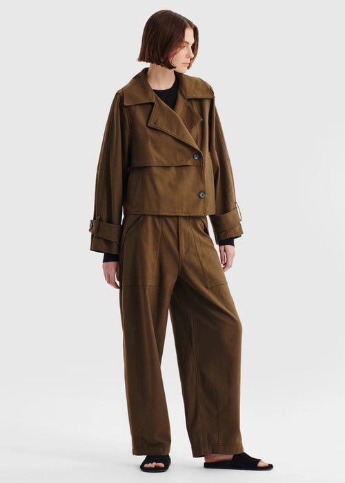 Woman wearing a brown coat on a white background