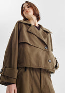 Woman wearing a brown coat on a white background