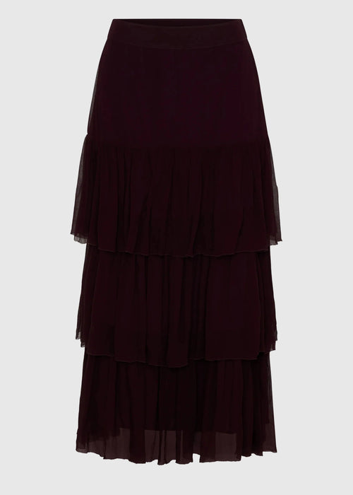 Dark purple tiered skirt on a light gray background